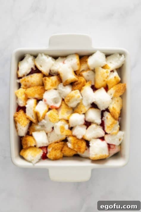 Cloud Nine Indulgence 12 Cake pieces over pie filling and more cake pieces in a pan.