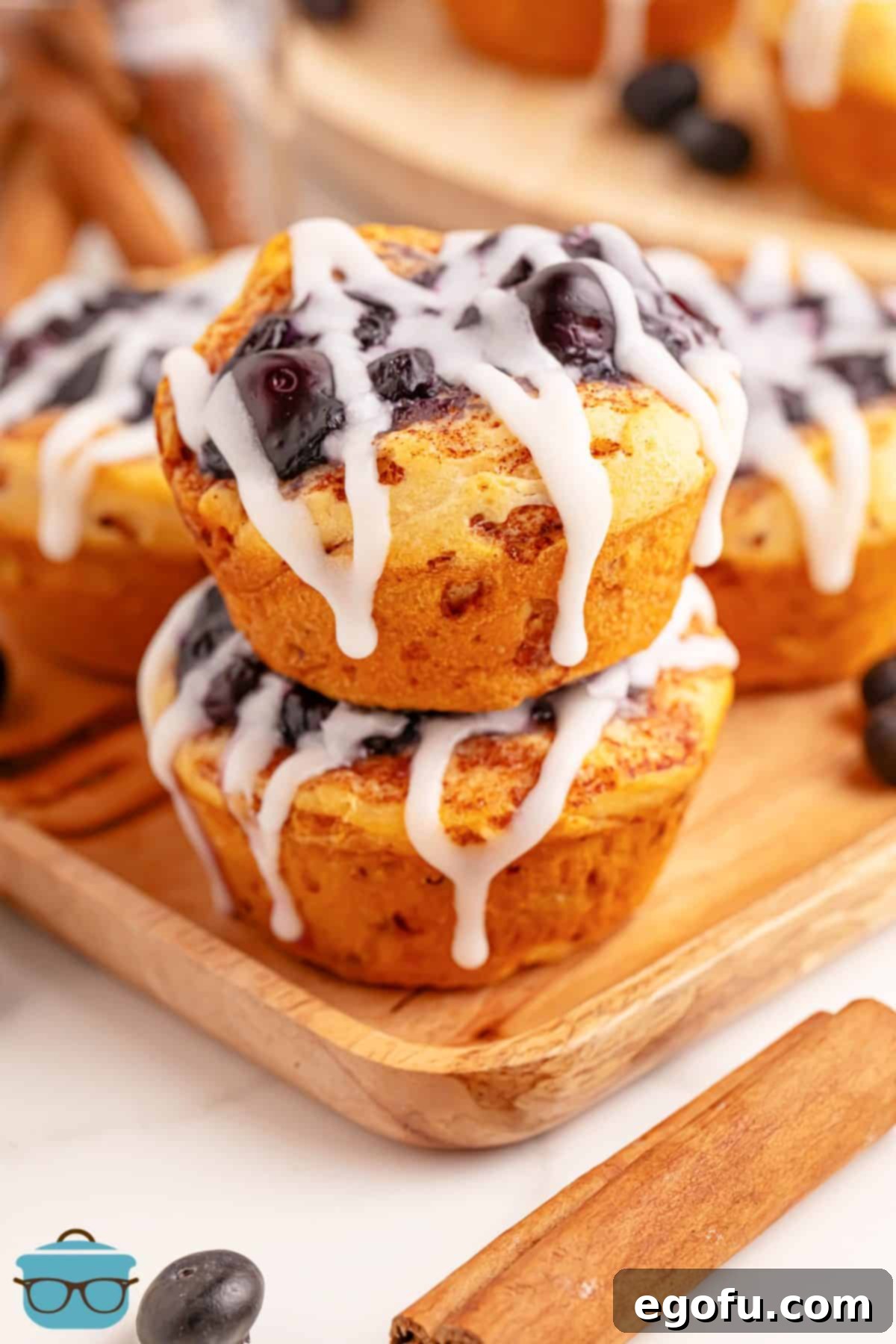 Blueberry Cinnamon Swirl Bites 2 Two stacked Blueberry Pie Cinnamon Roll Cups, beautifully showcasing their golden-brown edges and sweet blueberry filling.