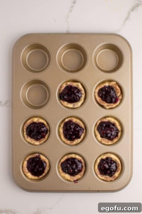 Blueberry Cinnamon Swirl Bites 9 Cinnamon roll dough cups with pie filling.