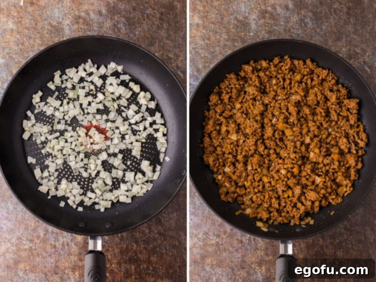 A skillet with diced onions cooking in oil.