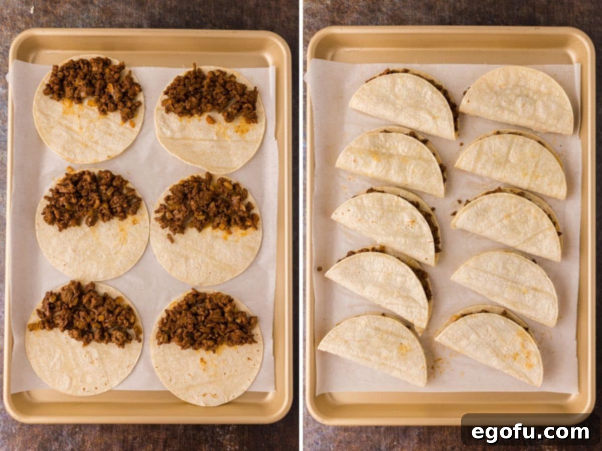 Ground beef filling placed on tortillas and folded in half on a baking sheet.