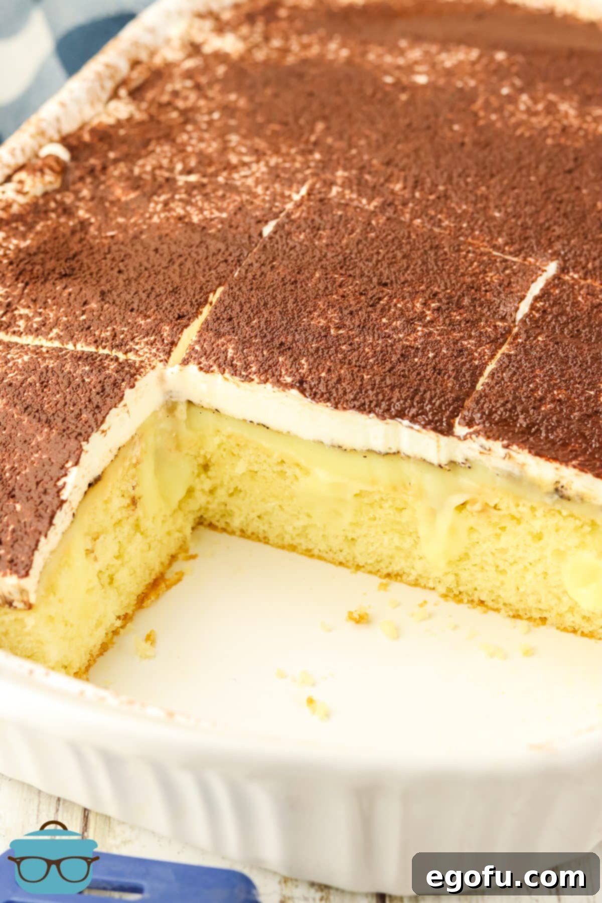 Espresso Kissed Tiramisu Poke Delight 2 A few slices of Tiramisu Poke Cake left in a baking dish.