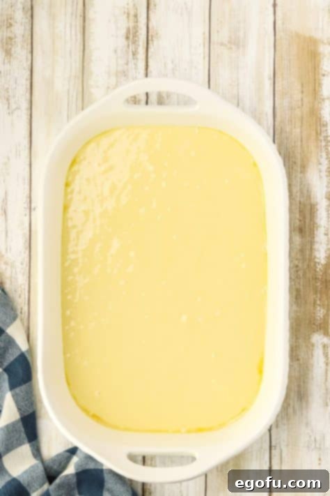 Espresso Kissed Tiramisu Poke Delight 12 Cake batter in a cake pan.