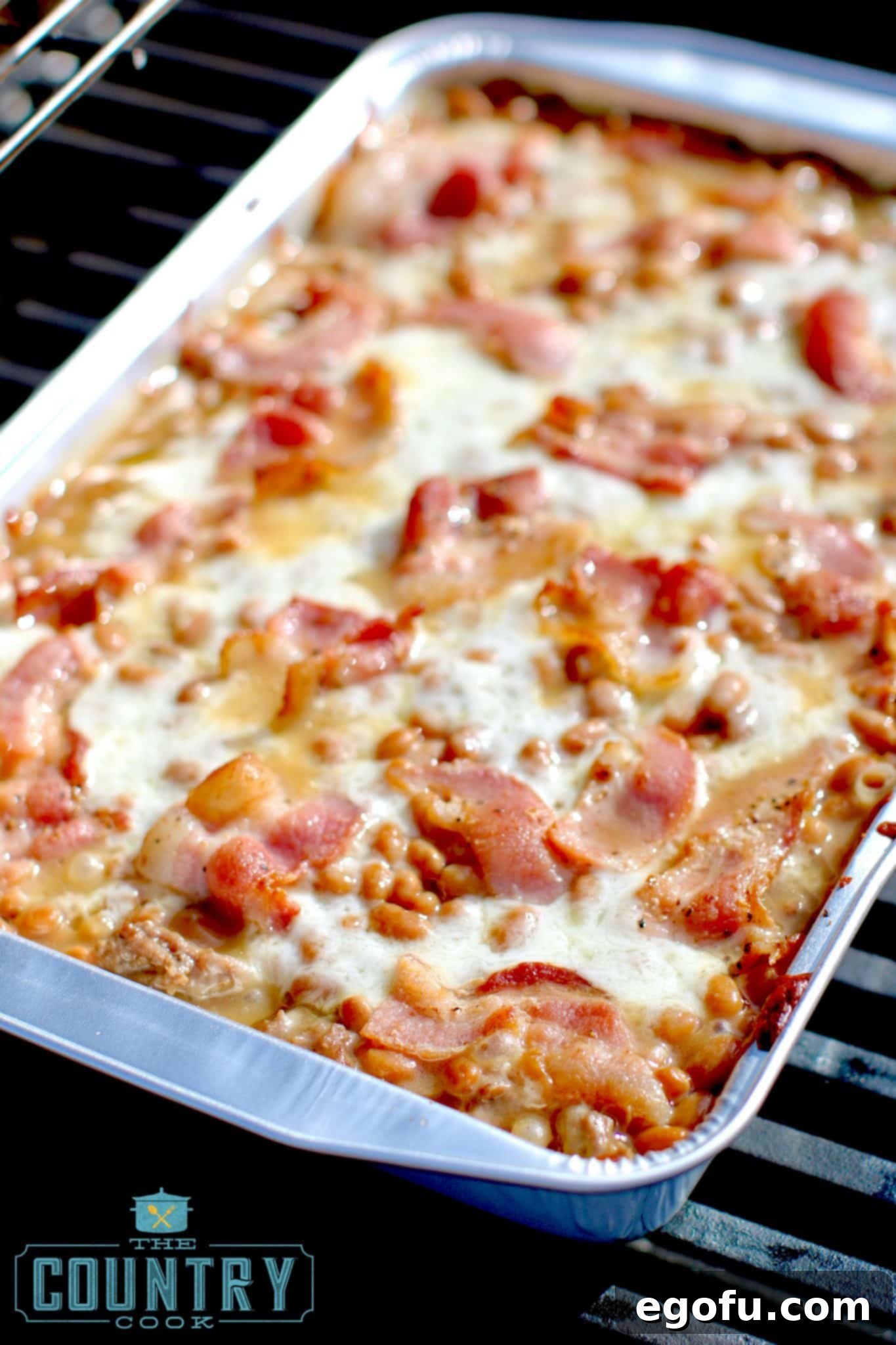 The fully baked Beef and Bean Cowboy Casserole, bubbly and golden, removed from the grill.