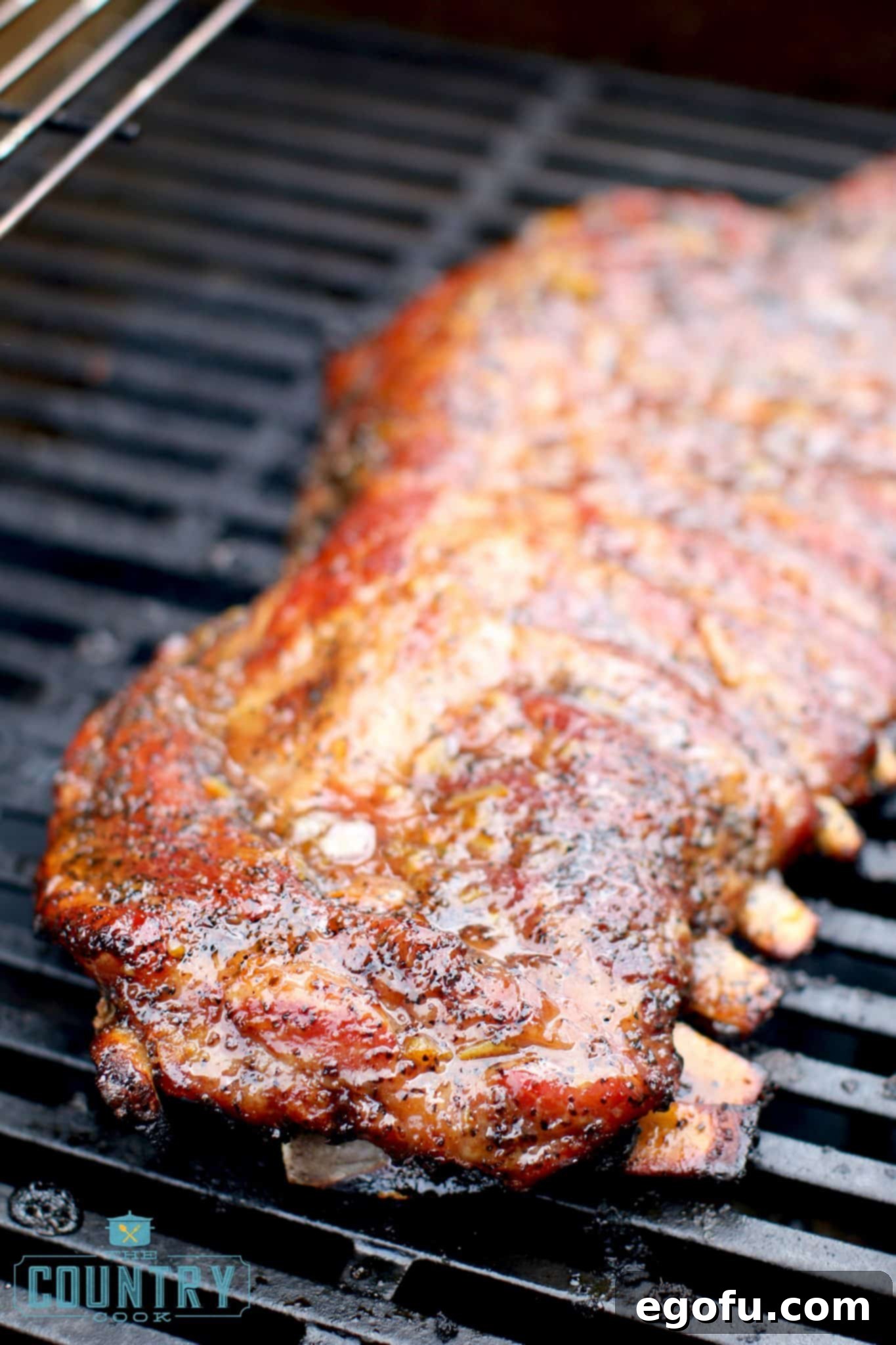 fully cooked pork ribs on a gas grill.
