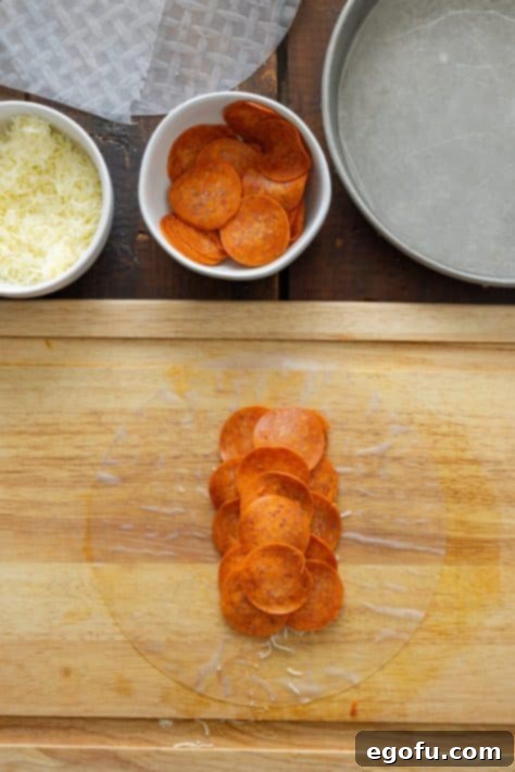 Pepperoni and cheese on a spring roll wrapper.