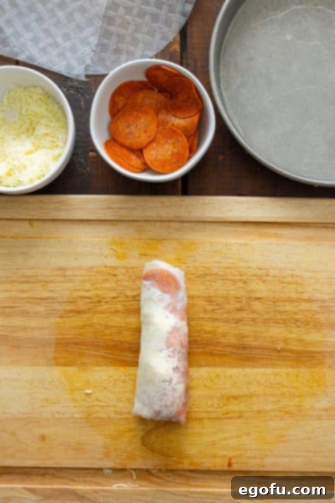 An unbaked Pizza Spring Roll.