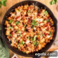 Smoky BBQ Chicken and Crispy Potato Skillet 11 Looking down on a large skillet with BBQ Chicken Potato Skillet.