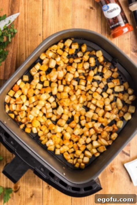 Smoky BBQ Chicken and Crispy Potato Skillet 13 Cooked and seasoned potatoes in an Air Fryer basket.