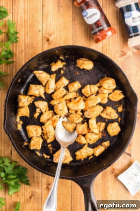 Smoky BBQ Chicken and Crispy Potato Skillet 16 Garlic and chicken in a skillet cooking.