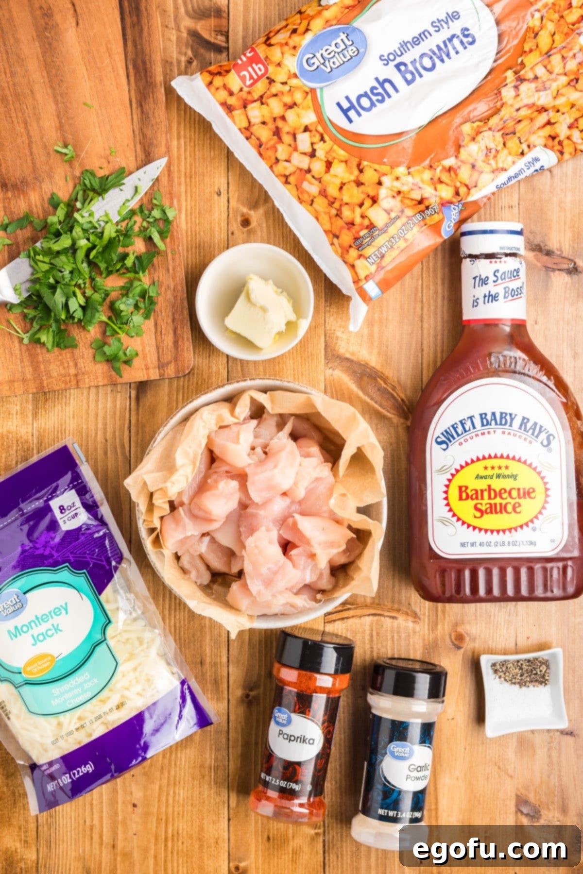 Smoky BBQ Chicken and Crispy Potato Skillet 5 Southern hash browns, coarse kosher salt, black pepper, garlic powder, paprika, chicken, unsalted butter, garlic cloves, Sweet Baby Rays, shredded Monterey Jack cheese, parsley.