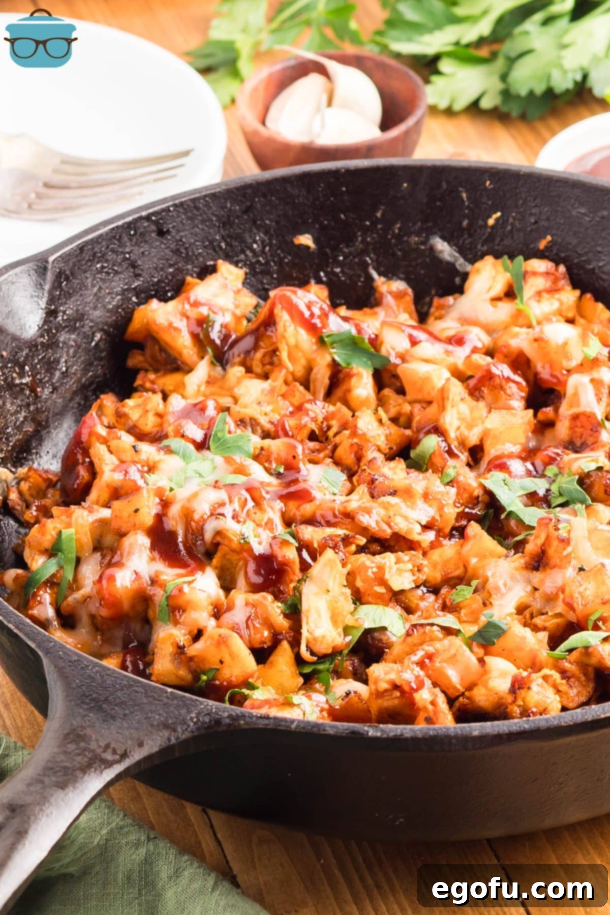 Smoky BBQ Chicken and Crispy Potato Skillet 10 A BBQ Chicken Potato Skillet on a wooden serving board.