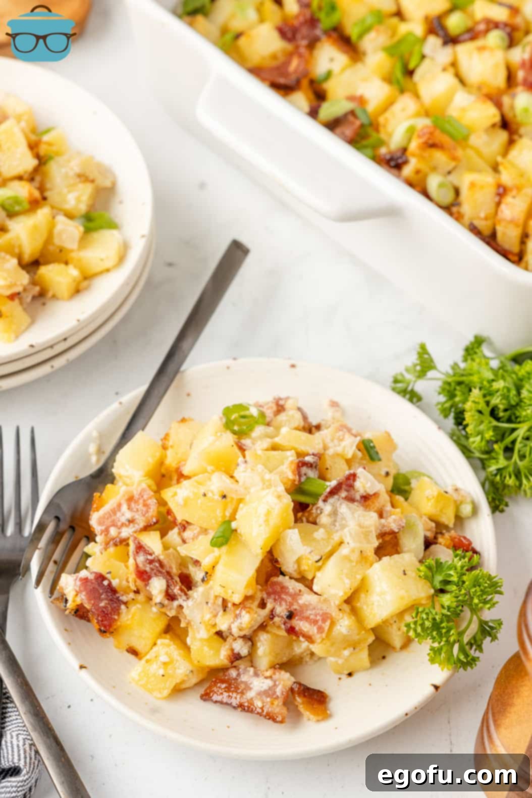 A close-up of a forkful of Mississippi Mud Potatoes on a plate, showing the texture and ingredients.