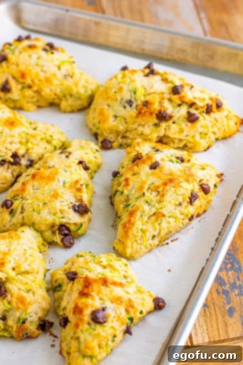 Golden brown scones on a lined baking sheet.