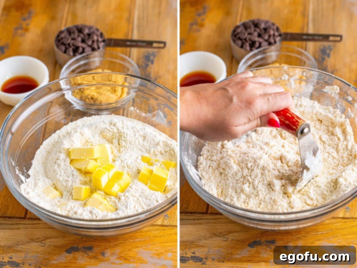 Slices of butter being cut into dry ingredients in a bowl.
