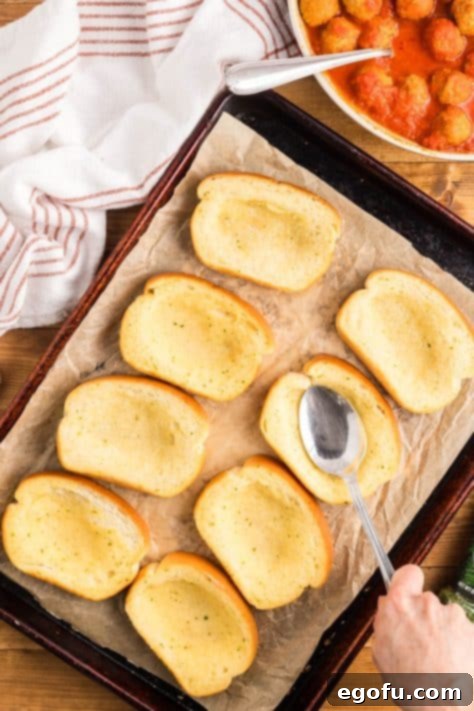 A spoon making indents on pieces of Texas Toast.
