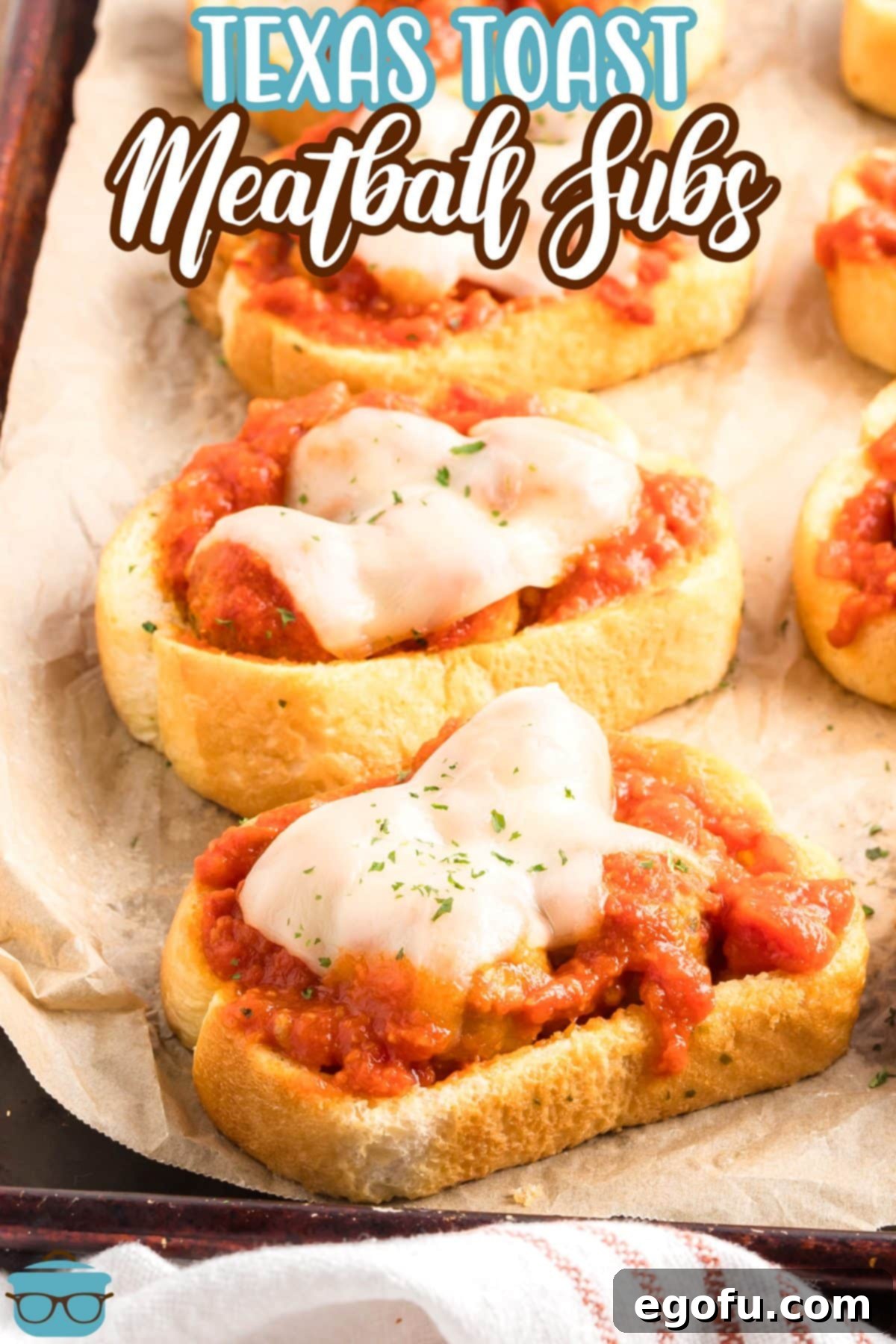 A few pieces of Texas Toast Meatball Subs on a piece of parchment.