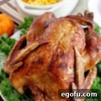 Crispy deep-fried turkey ready for serving, garnished with fresh parsley.