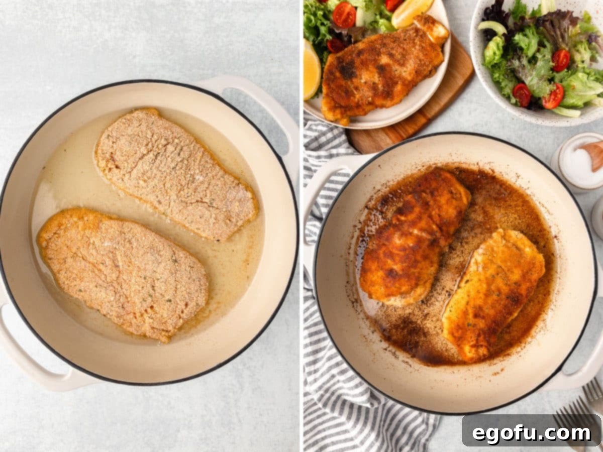 Coated chicken breast in a skillet of oil being cooked.