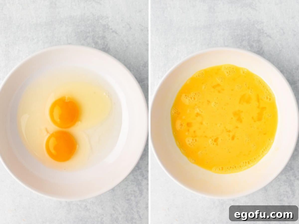 A bowl with eggs and water being mixed together.