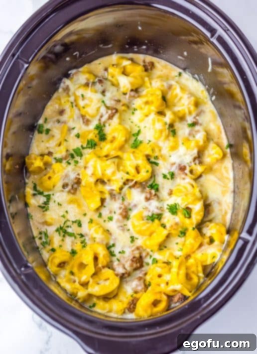 Heavy cream and cheese mixture added to a Slow Cooker Cheesesteak Tortellini dish.