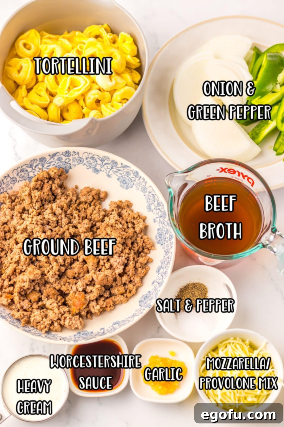 Ground beef, tortellini, beef broth, salt, pepper, Worcestershire sauce, onion, green bell pepper, minced garlic, heavy cream, and shredded cheese.