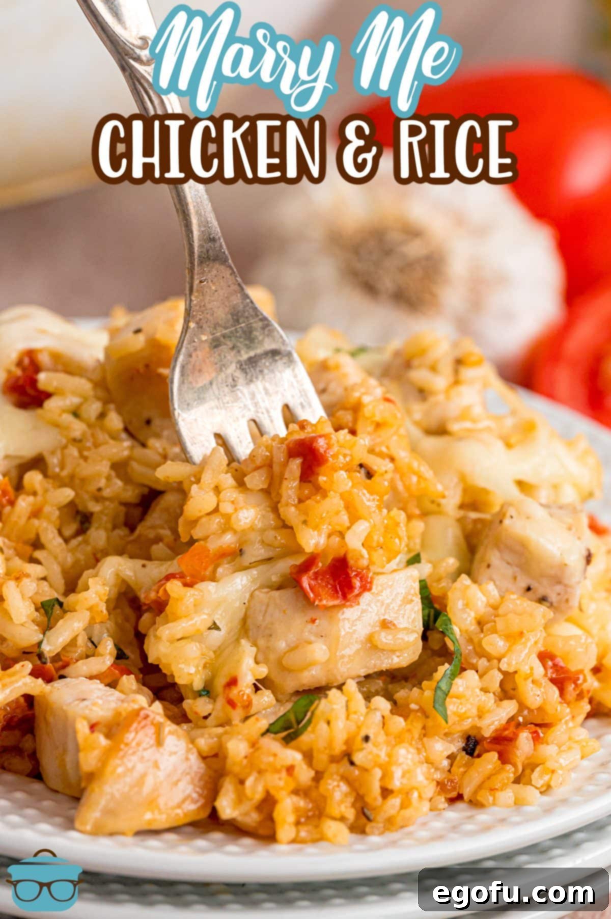 A fork in a full, appetizing plate of Marry Me Chicken and Rice, ready to be enjoyed.