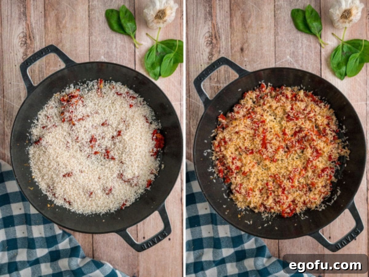 White rice being stirred into a skillet with garlic and tomatoes.