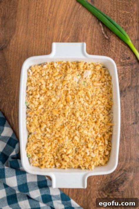 Crumbled Ritz cracker mixture on top of an unbaked casserole mixture.