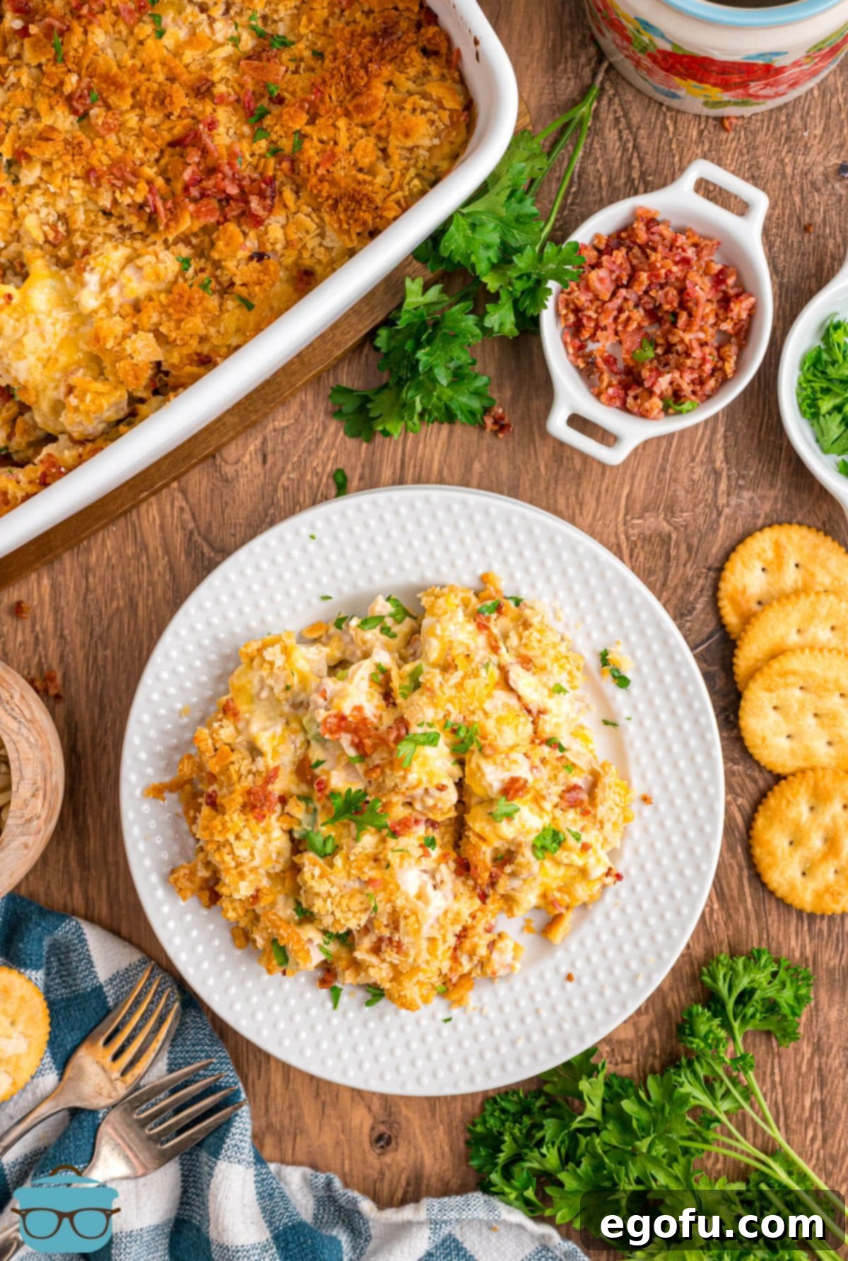 A plate of Neiman Marcus Chicken Casserole next to the rest of the baking dish.