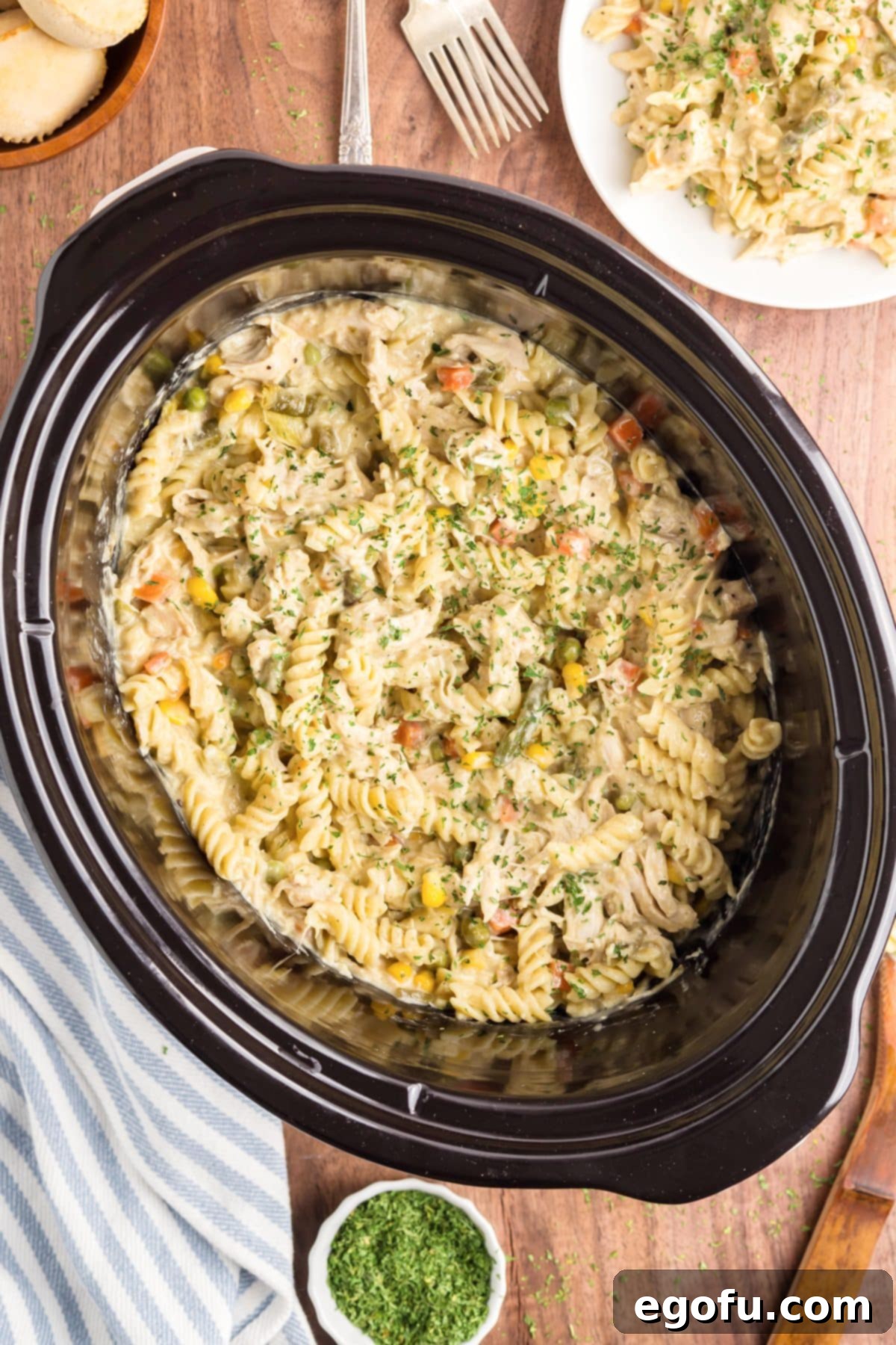 Ultimate Slow Cooker Chicken Pot Pie Pasta 2 Looking down on a Slow Cooker filled with Slow Cooker Chicken Pot Pie Pasta.