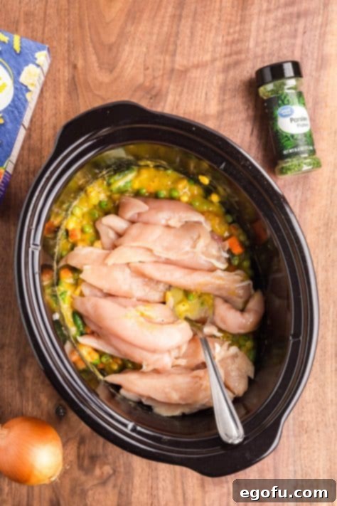 Ultimate Slow Cooker Chicken Pot Pie Pasta 11 A Slow Cooker with all the ingredients to make a Chicken Pot Pie Pasta dish.