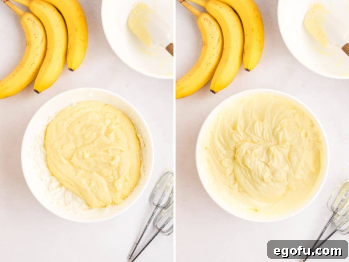 The combined banana pudding and cream cheese mixture being blended with an electric hand mixer until perfectly smooth.