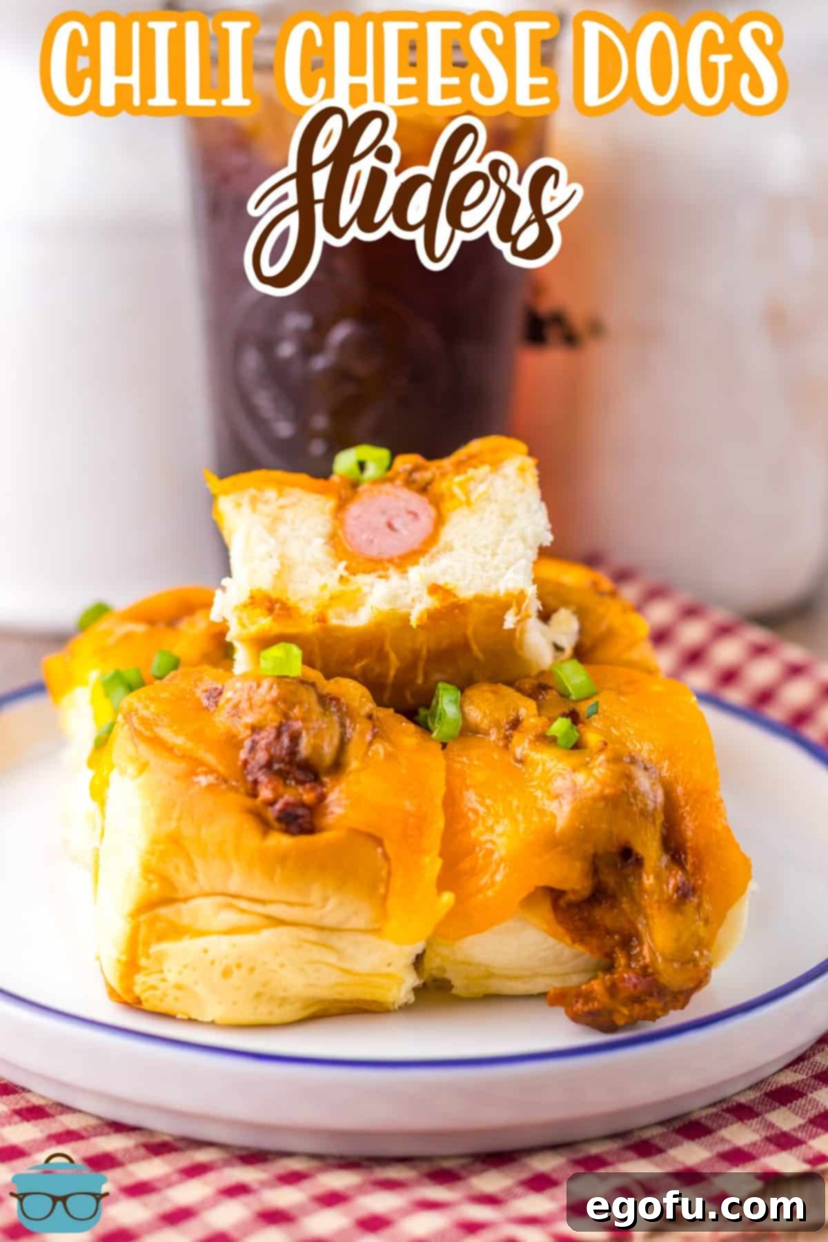 A few Chili Cheese Dog Sliders on a white plate with blue trim, ready to be enjoyed.
