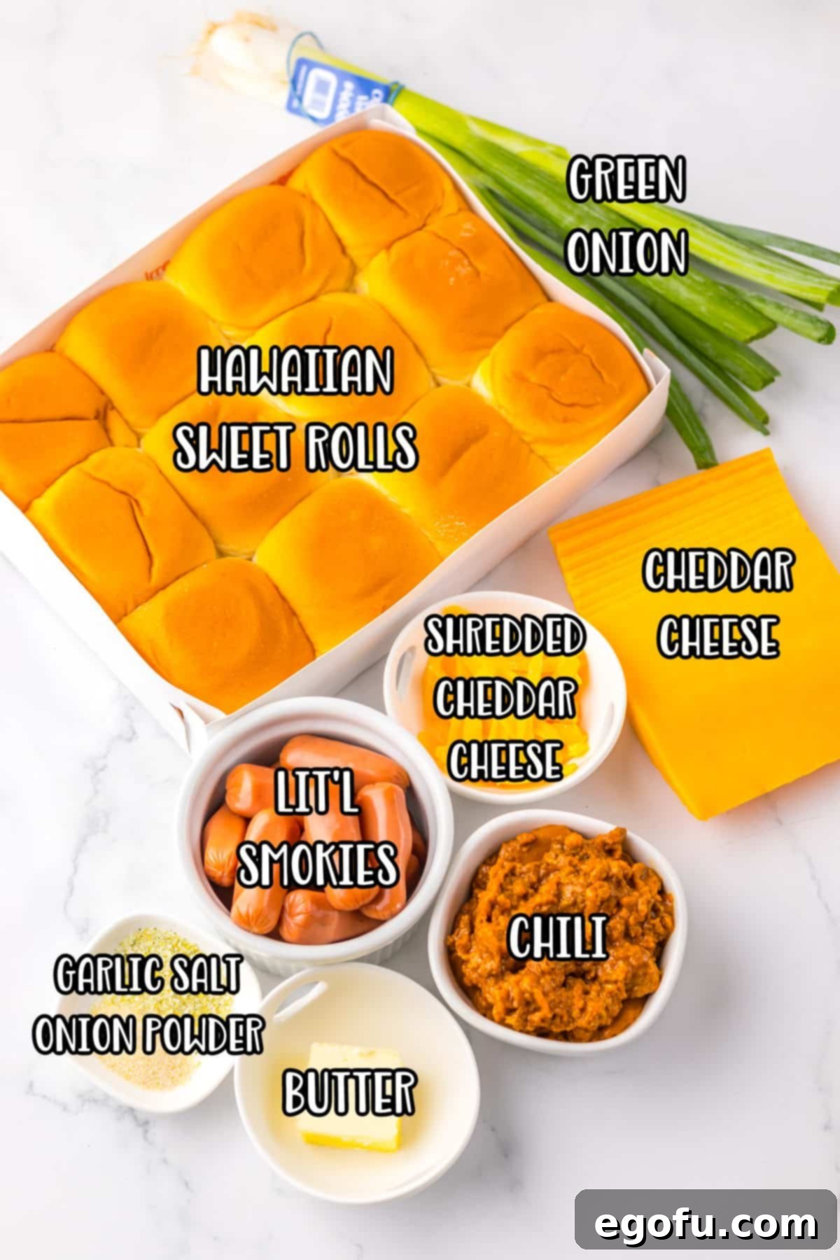 Hawaiian sweet rolls, cheddar cheese, chili, green onion, Lil Smokies, shredded cheddar cheese, garlic salt, onion powder, and butter laid out as ingredients.