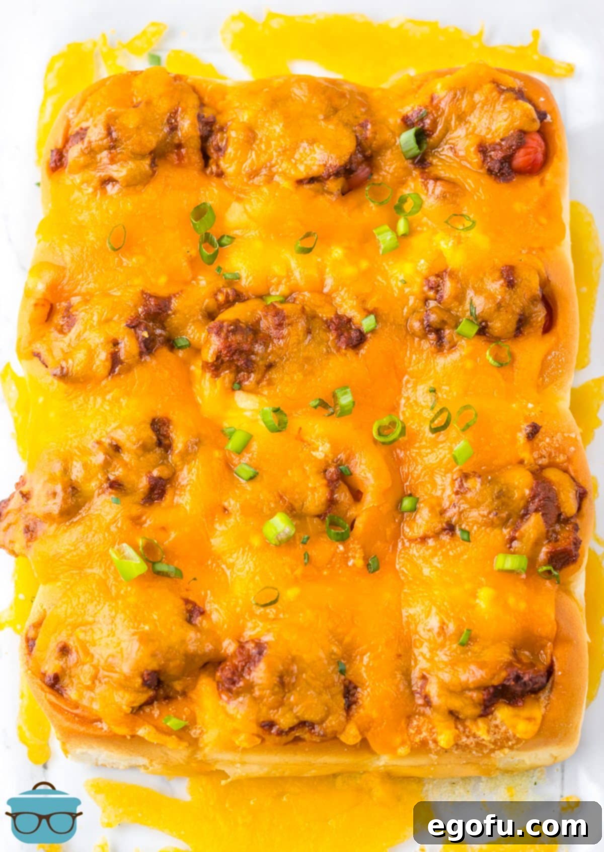 Looking down on a pile of baked Chili Cheese Dog Sliders, ready to serve.