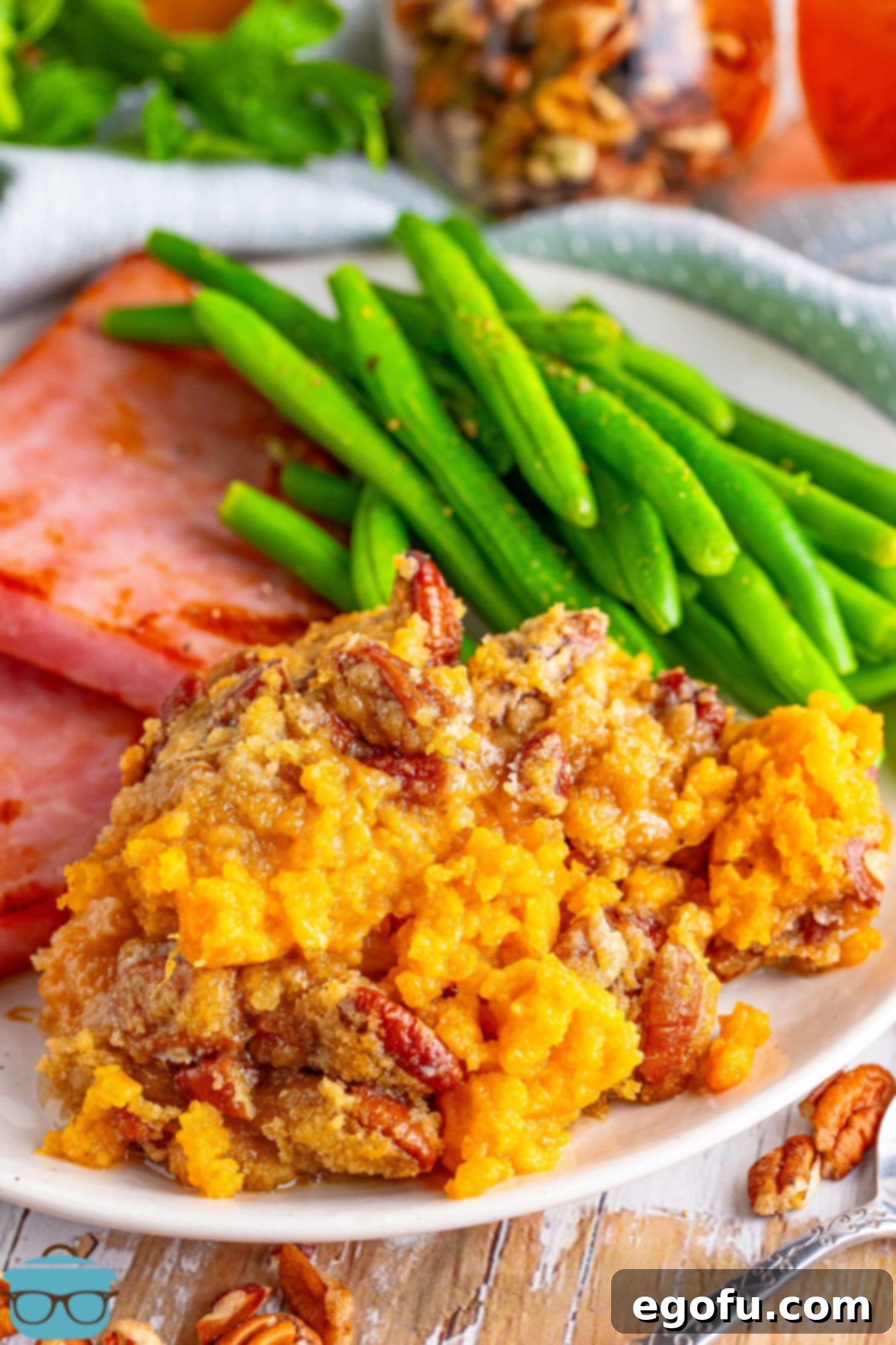 A plate with a side of green beans and Sweet Potato Casserole, showcasing a perfect holiday meal.