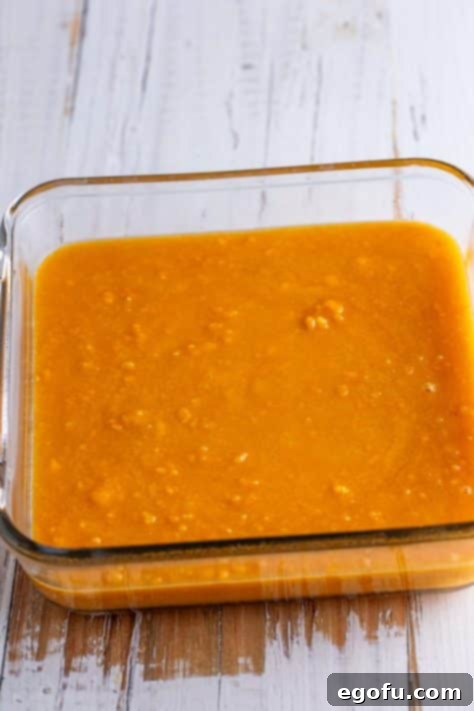 The sweet potato mixture poured into an 8-inch square baking dish.