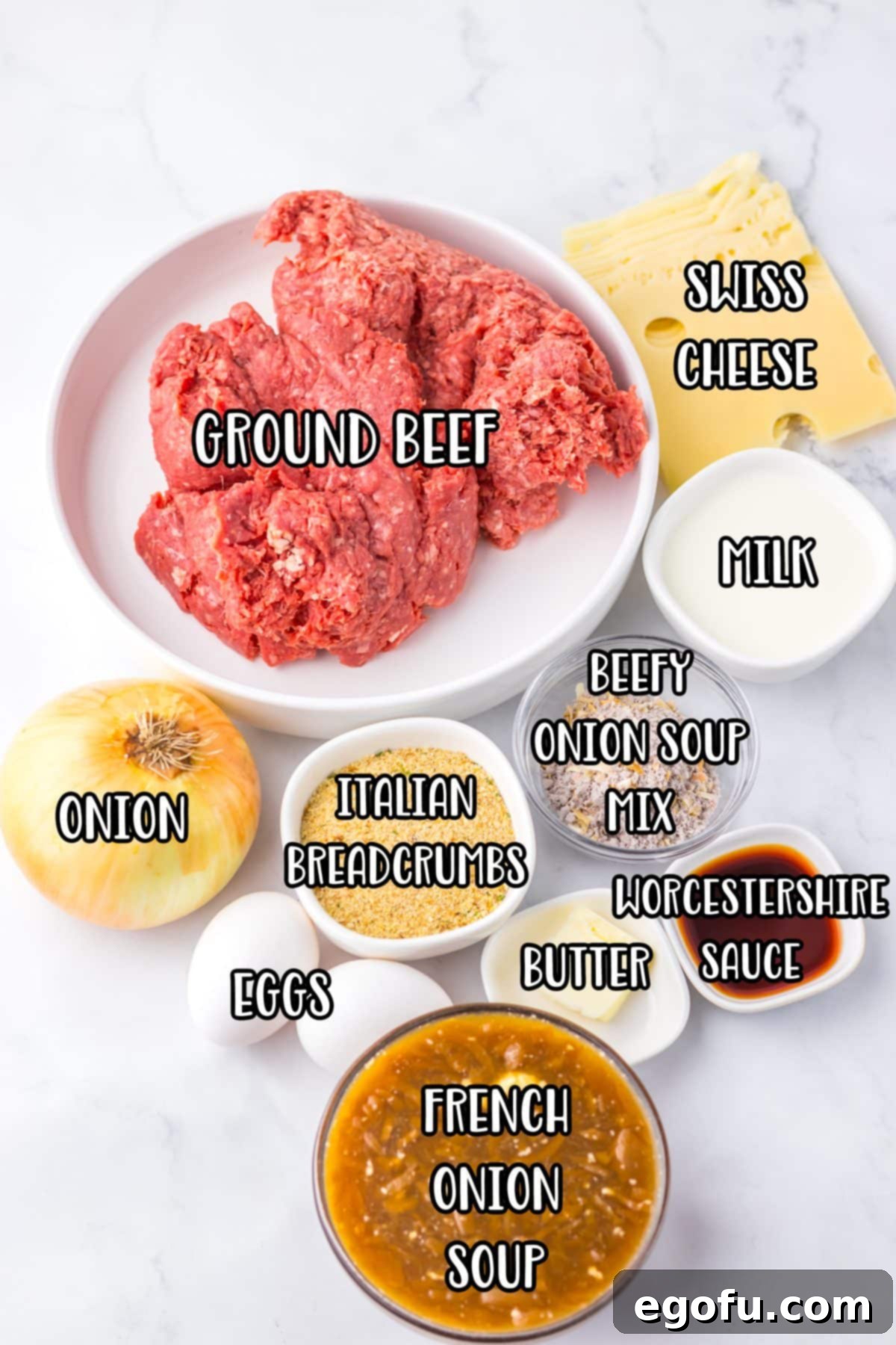 A vibrant display of all the ingredients needed for Crock Pot French Onion Meatloaf, including ground beef, onions, cheese, and seasonings.