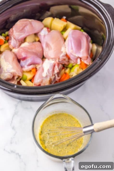 A bowl with chicken broth, chicken gravy mix and ranch seasoning mix being prepared.