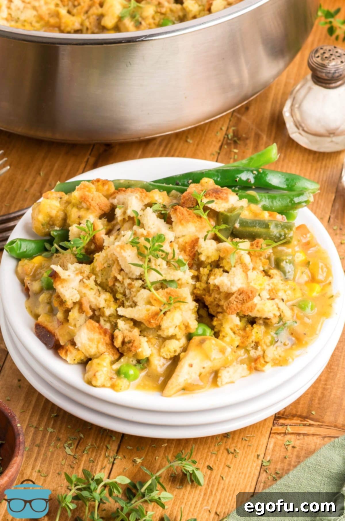 A large serving of One Pot Chicken Stuffing Casserole on plates, ready to be enjoyed.