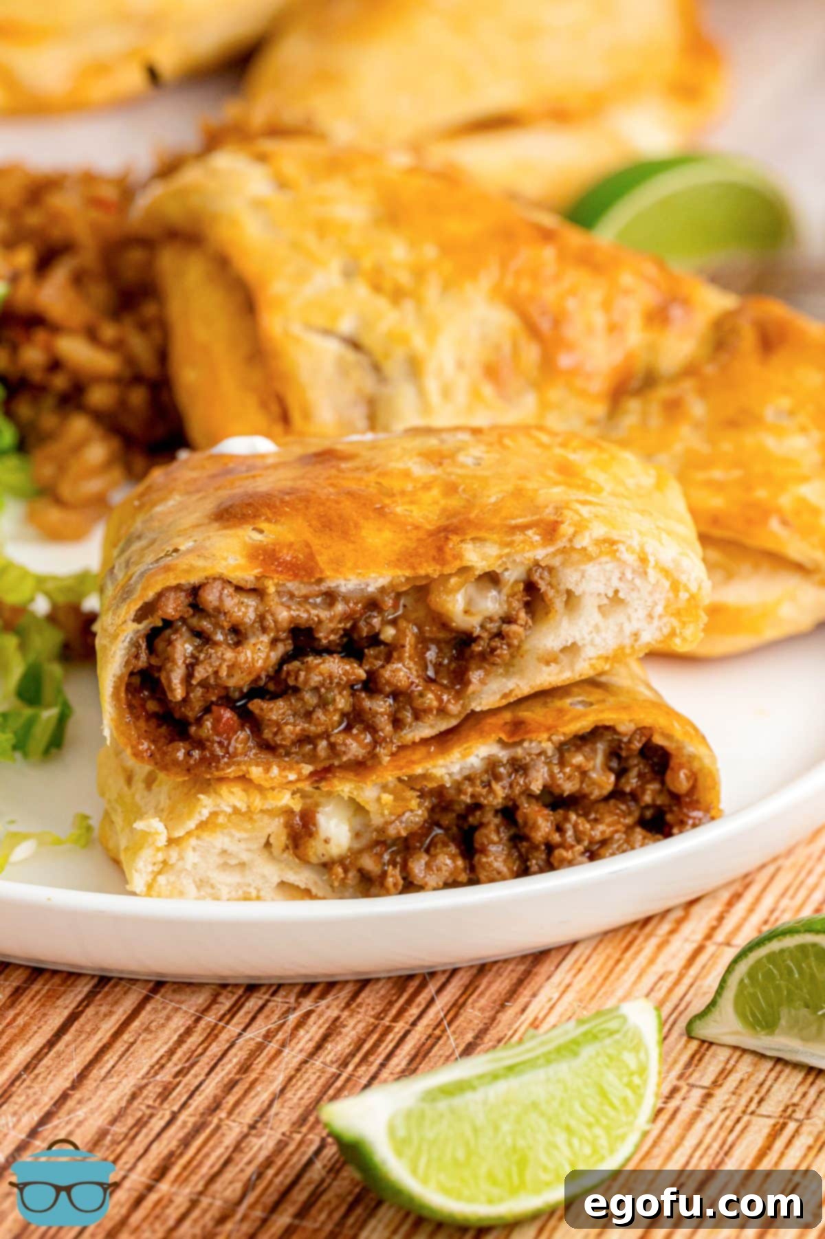 A plate with a cut Taco Pocket waiting to be eaten, showcasing the cheesy, meaty filling.