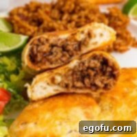 Looking inside a cut Taco Pocket stacked on top of itself, showing the savory filling.