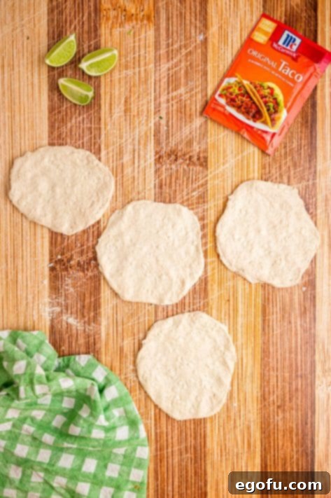 Biscuit dough pieces rolled out flat into circles.