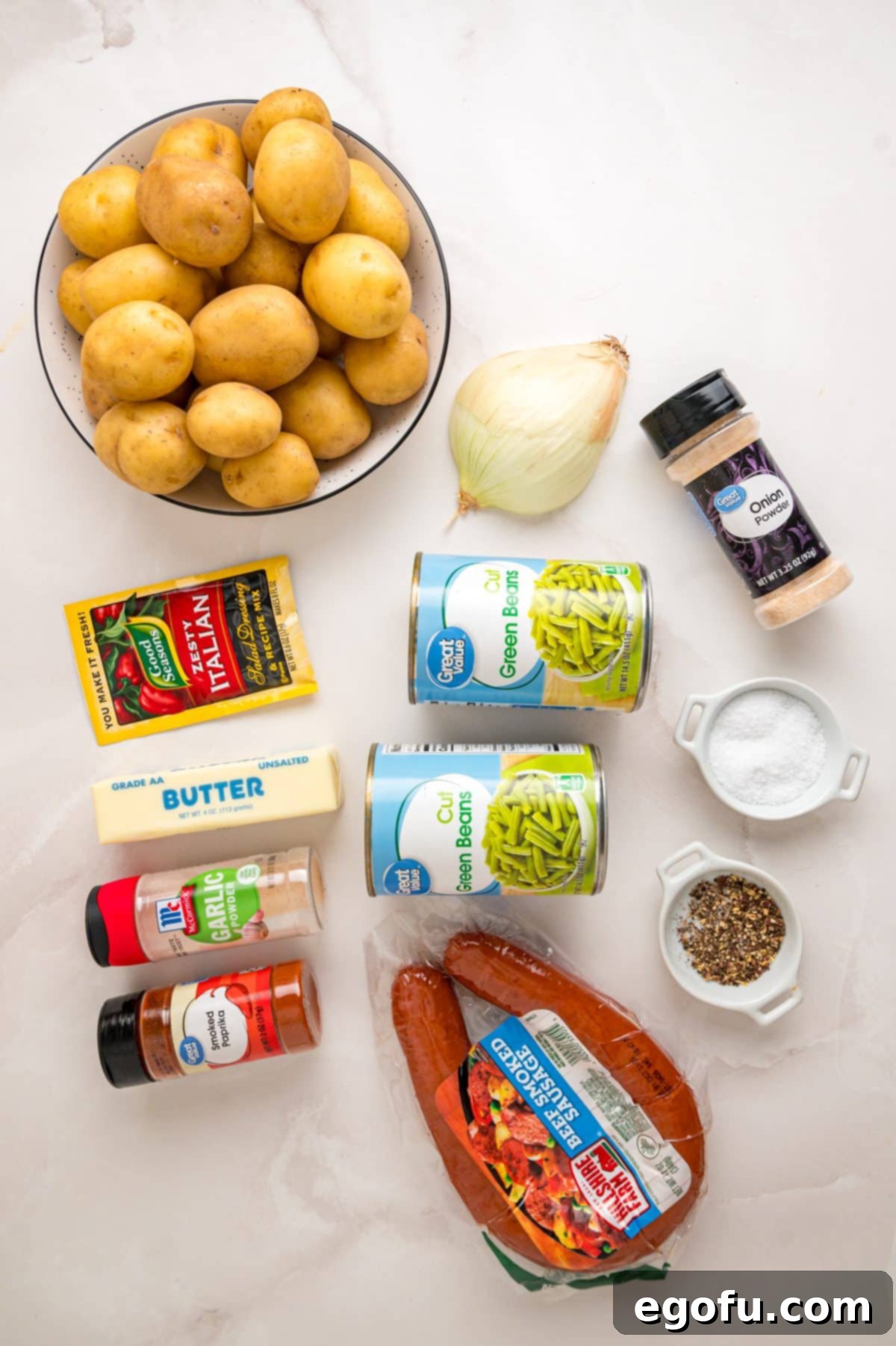 Bayou Slow Cooker Potatoes 5 Yellow potatoes, kielbasa, salt, pepper, garlic powder, onion powder, paprika, yellow onion, green beans, Italian seasoning mix, and butter.