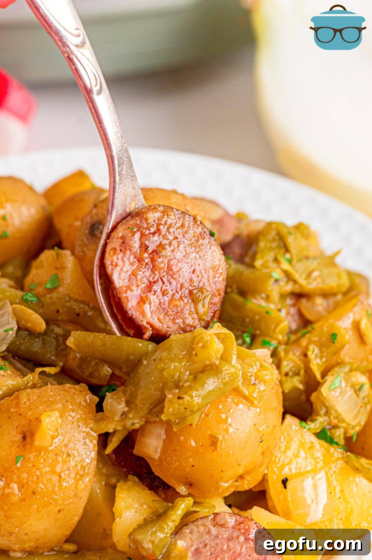 Bayou Slow Cooker Potatoes 14 A fork getting a bite of Crock Pot Swamp Potatoes.