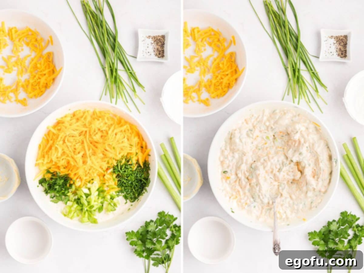 Shredded cheddar cheese and fresh herbs being added to the cream cheese mixture in a bowl and mixed.