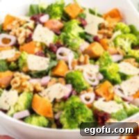 Close up looking at a bowl of Autumn Salad, highlighting the fresh textures and vibrant colors.