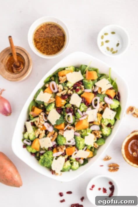 Combining various salad ingredients in a medium bowl.