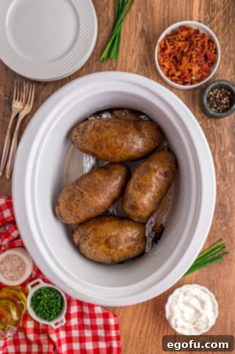 Baked potatoes in a Slow Cooker, showing a perfectly cooked batch.
